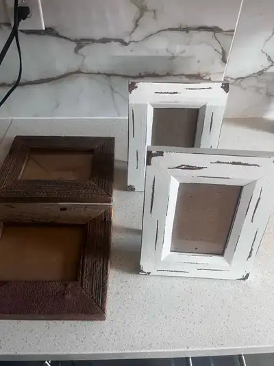 four rustic picture frames! Two are a darker wood tone and two are painted white with a distressed l...