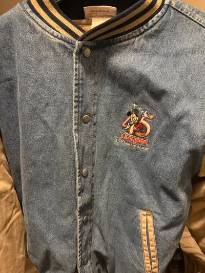 Relive the magic with this Disney & Produced exclusively for Disneyland 45th Anniversary jean jacket...