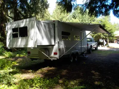 The Queen bedroom slides out the back. Front bunks. Sofa / bed. Booth dinette / bed. Kitchen with fr...