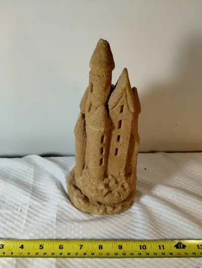 Add a touch of whimsical coastal charm to your home with this unique sandcastle figurine. This pre-o...