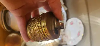 Vintage floral and cherubs brass lighter $60 located in kingsville