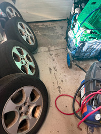 4 x Subaru Forester rims and worn tires.
