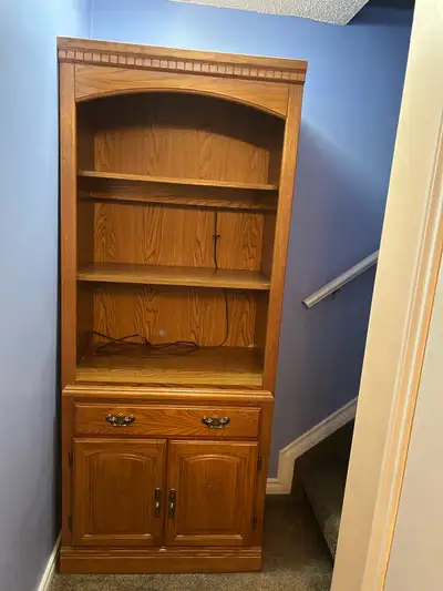 Solid oak cabinet/shelf unit. Amazing condition nothing wrong with it, has a built in light great to...