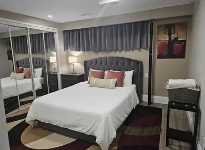 A beautiful, spacious bedroom in the basement of a split-level house is available for short-term ren...