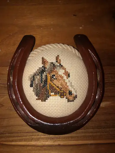 Add a touch of rustic charm to your space with this unique, used horseshoe decoration featuring a cr...