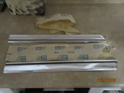 2 NOS GM body mouldings with original wrappers. One is part number 3894655, the other is the same pa...