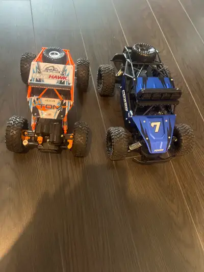 Get ready for some off-road excitement with these RC rock crawler trucks! They are in good condition...