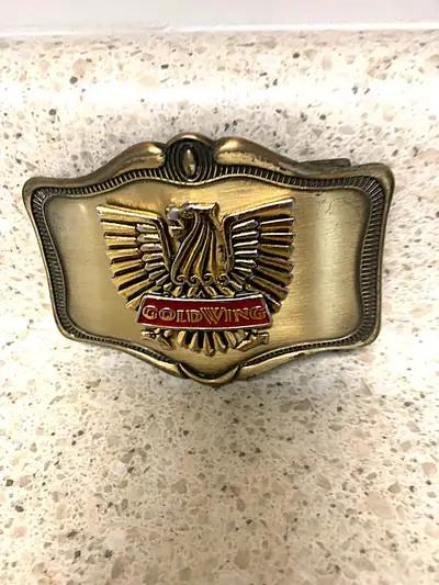 Crafted with a classic touch, this Belt Buckle is a genuine piece hailing from the 1978 GoldWing Mot...