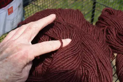 Fifteen ounces of beautiful burgundy yarn. Possibly Aran or Light Bulky weight. Comes in a huge skei...