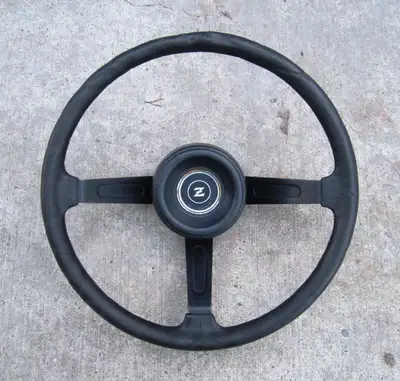 1977-78 Datsun Nissan 280z black steering wheel with horn button. Has some damage on the top as pict...