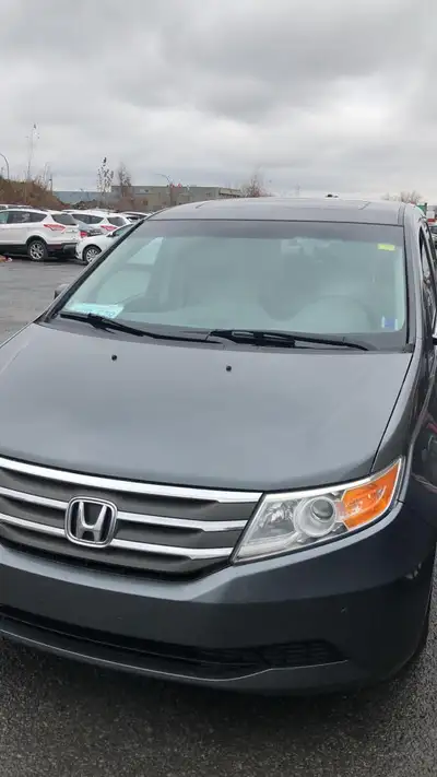 I am selling a 2011 Honda Odyssey that is perfect for families, offering spacious seating and a smoo...