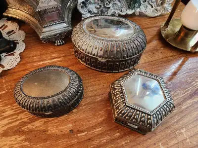 Vintage set of three silver tone jewelry boxes with ornate beaded/ridged border detailing. Branded "...
