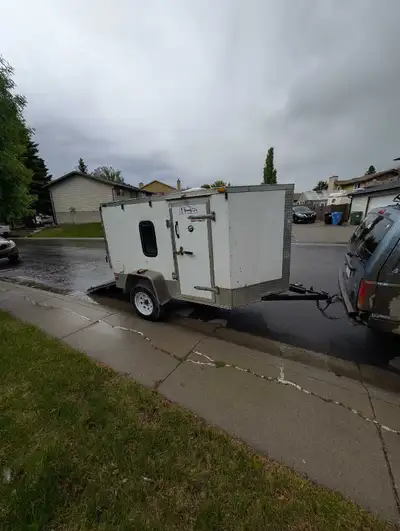 2012 enclosed cargo trailer for sale. Converted to a small camp trailer with a fold down bunk and a...