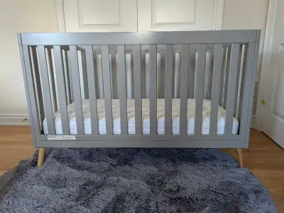 Delta Convertible Tucker 4-in-1 baby crib in grey. Sealy Posturepedic Evolution mattress included. S...