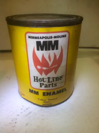 This can has a paper label. The can is about 1/3 full of paint