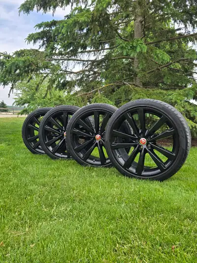 A set of four gloss black factory 20" jaguar rims and tires from a jaguar xf with 255/35 R 20 used r...