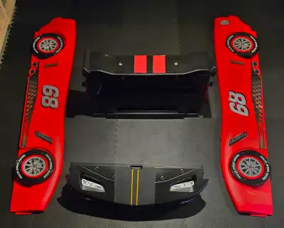 Up for sale is a Delta Children "Delta Speed Racing" race car twin bed — a bold red and black molded...