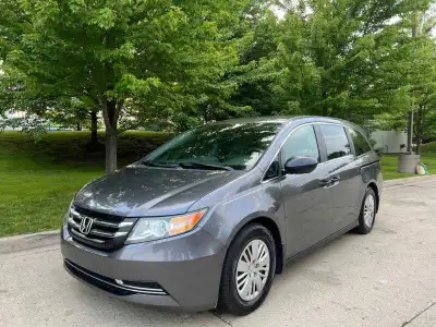 This 2014 Honda Odyssey LX is a reliable and spacious minivan, perfect for families or anyone needin...