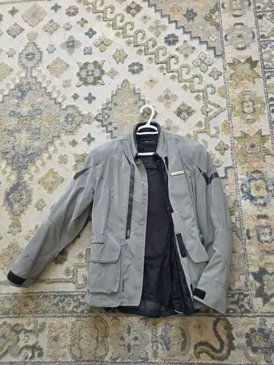 Women's touring jacket. Its entirely reflective, has two glue spots on the back since time of origin...