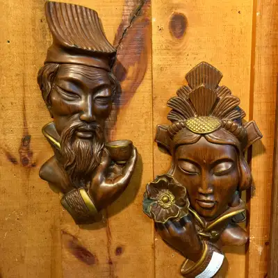 Incredible pair of mid century modern chalkware wall masks. Classic objects from when orientalism wa...