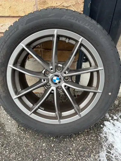 Original 17 BMW Rims with Bridgestone 225/50R17 98H winter tires in excellent pre-owned condition, f...