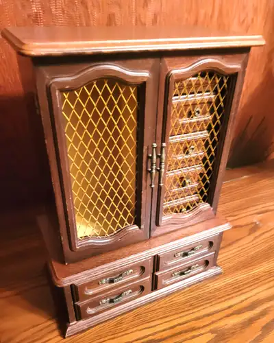 This grand-scale jewelry armoire is a beautiful example of late 1970s craftsmanship, offering an exp...