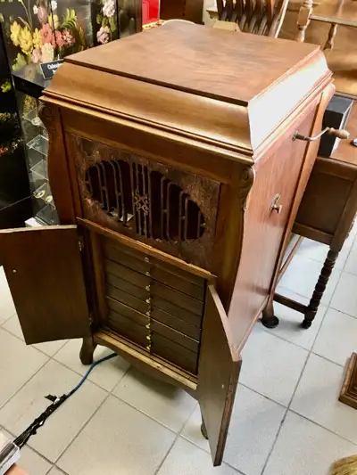 Offered for sale is an antique phonograph player and full cabinet constructed from premium solid wal...