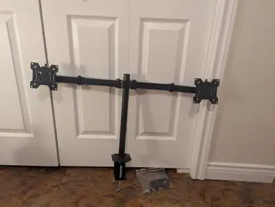 Adjustable monitor arms, can be clamped onto almost any desk. You will need an Allen key set to adju...