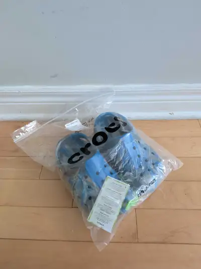 These are brand-new, unworn Crocs Baya Marbled Clogs, size J2, that come with the original tags and...