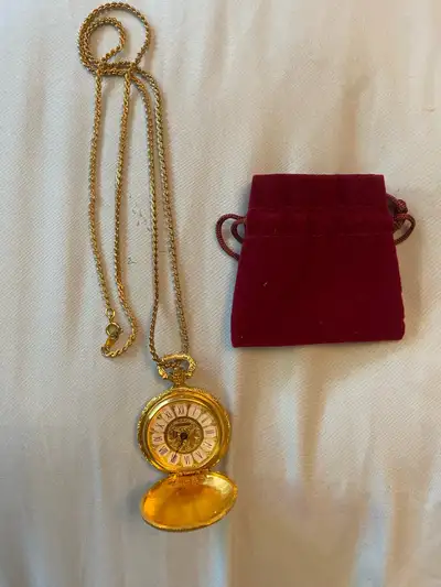 This vintage Swiss-made gold-plated pendant/pocket watch features a beautiful design and a 35mm diam...