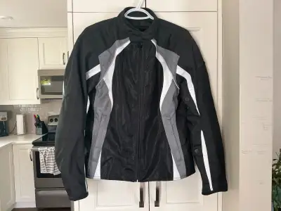 Grey and Black Bilt Motorcycle Jacket. Padded shoulders, zippered front pockets and zippers on sleev...