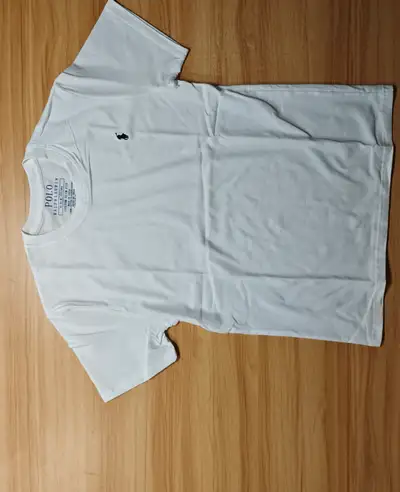 This is a Polo T-shirt in size medium. It is in good condition, perfect for casual wear or dressing...