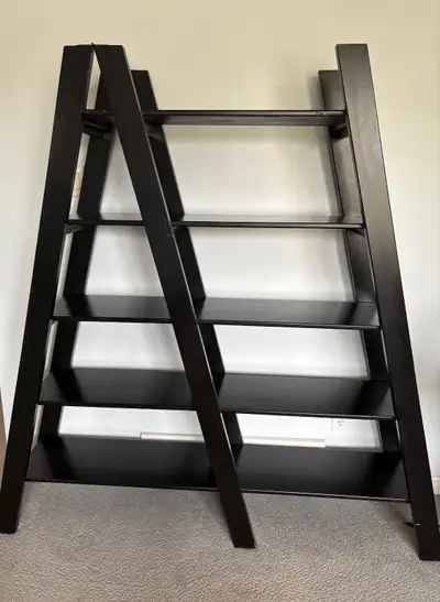 Unique A-shape bookshelf from Pier One. Black. Dimensions: 65" wide at base, 33" wide at top, 13 3/4...