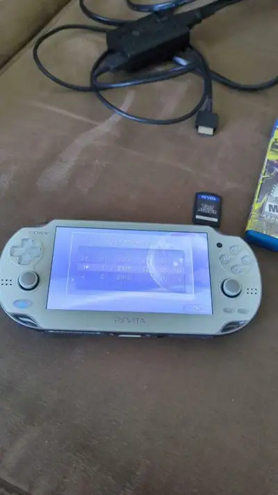 PS Vita with Charger, carrying case (has a stain on it), Persona 4 Golden, Final Fantasy X/X2, and M...
