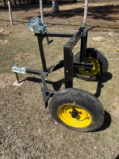 The trailer is built to lift one end of a log to make it easier for a quad or side by side to pull