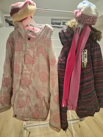 A striped winter jacket from SWS Athletics with a matching pink scarf. It's paired with a patterned...