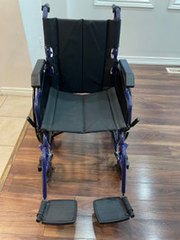 Wheelchair  - It has big wheels, hand brakes, feet support 