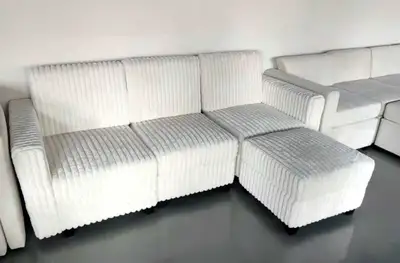 Upgrade your living space with this stylish and versatile ivory corduroy modular sofa, complete with...