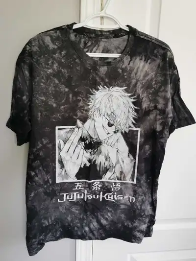 This is a new Jujutsu Kaisen graphic t-shirt featuring Gojo Satoru in a tie-dye style. It's perfect...