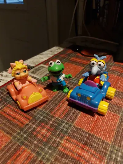 I am selling a set of used Muppet Babies figurines, including Miss Piggy in her pink car, Kermit the...