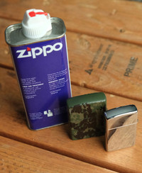 Barely used Zippo lighters, stainless and camouflage. $35