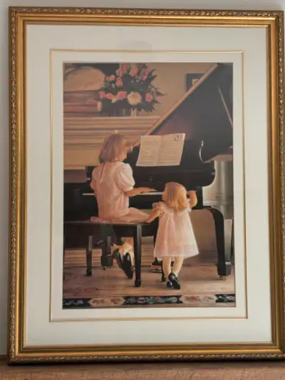 Large gold framed wall art entitled “Dress Rehearsal” by Greg Olsen. Depicts two young girls at gran...