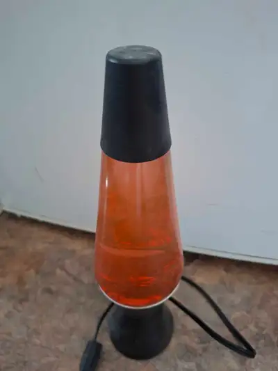 Add a touch of retro charm to your living space with this classic orange lava lamp, perfect for crea...