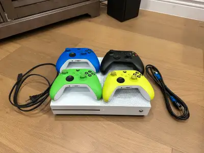 1TB Xbox one X with 4 wireless controllers, power cord, HDMI cable, and an assortment of Xbox 360 ga...