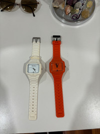 Men’s white and orange Nixon Watch