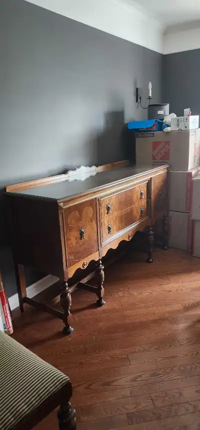 This is a vintage walnut buffet from 1930's, perfect for adding a touch of classic elegance to your...
