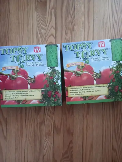 Two Topsy Turvy, upside down tomato planters. Hang from patio, deck or baloney. Suitable also for cu...