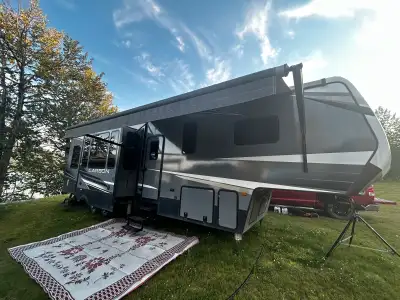 2019 keystone carbon toy hauler Toy garage with bunk beds and couches and a patio with awnings Large...