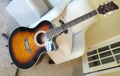A Jay Turser acoustic/electric guitar, Model J2A4200CET-TSB (Tobacco Sun Burst). The electrics needs...