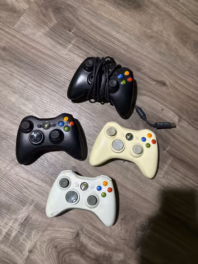 4 Xbox 360 Controllers. One controller has instant charger.